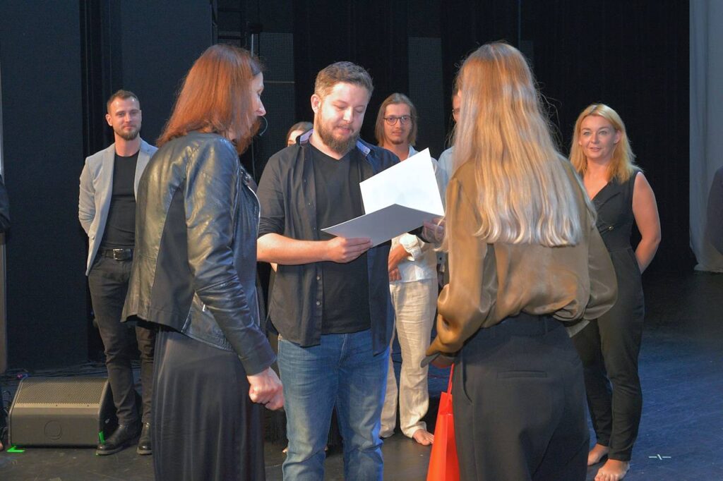 Łukasz Jędrys odbiera dyplom od Agnieszki i Julii Gintrowskich